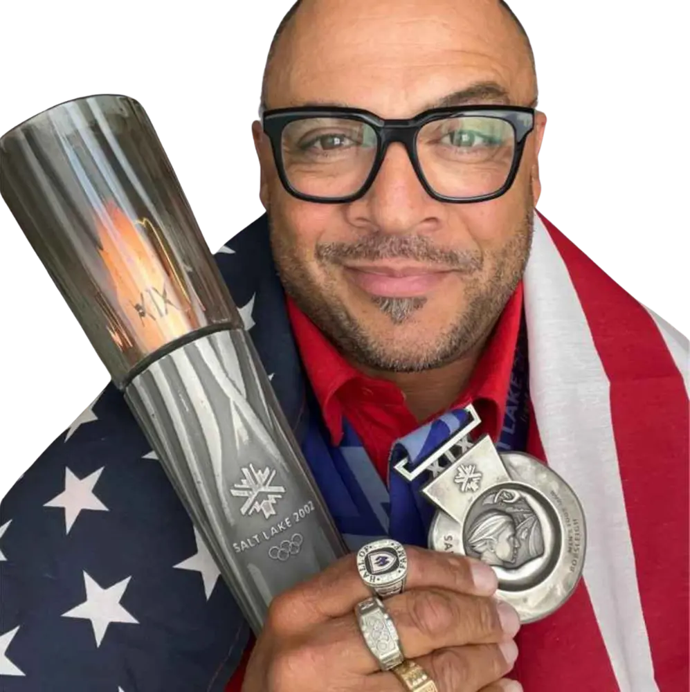 Bill Schuffenhauer holding the 2002 Salt Lake Olympic torch and his silver medal